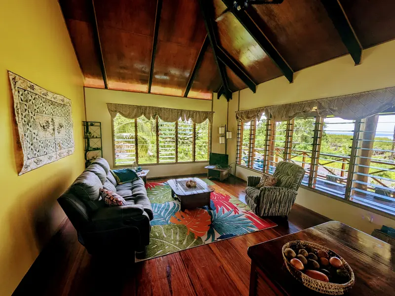 Living room with timber ceiling, sofas and big windows